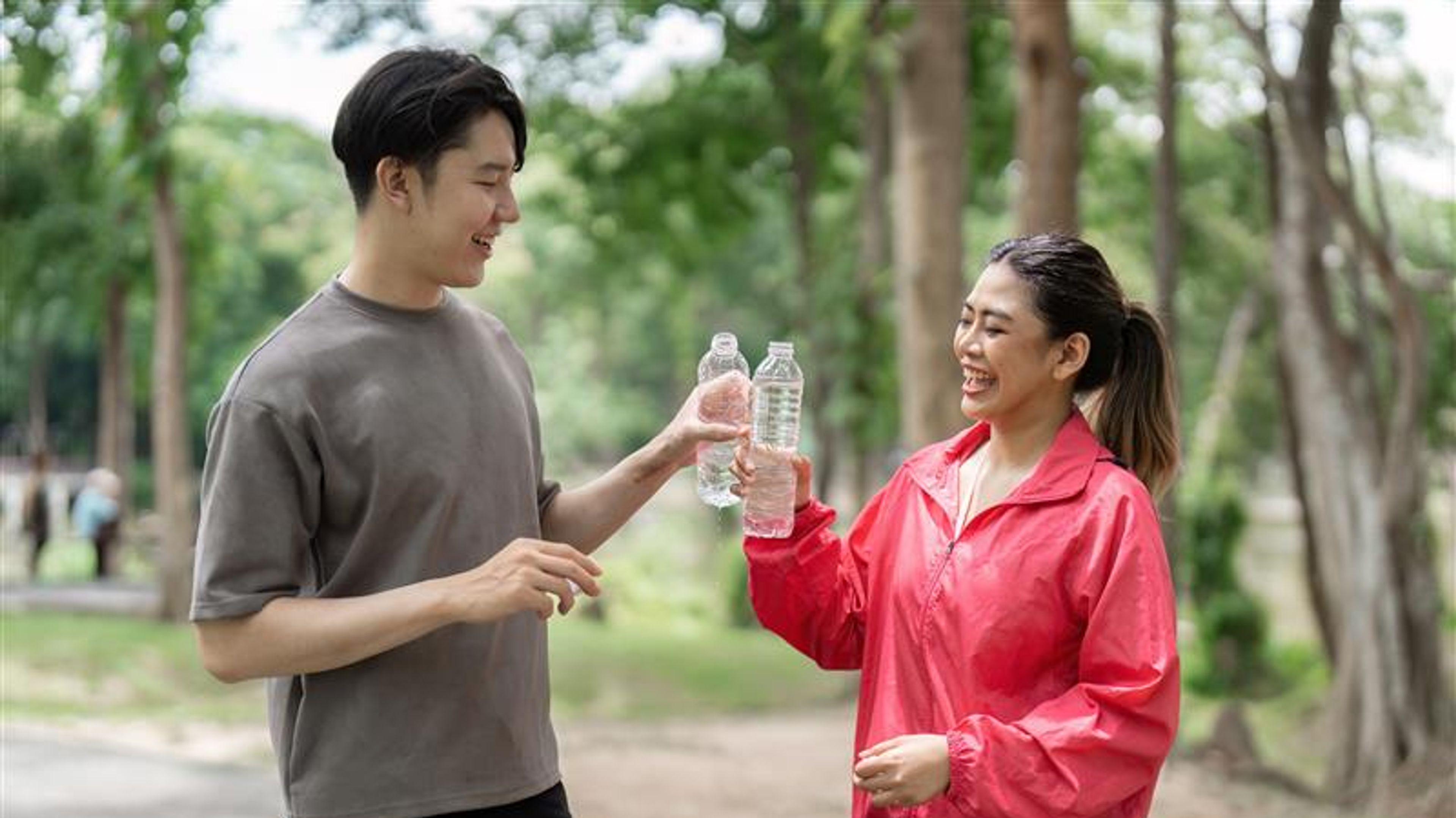A couple sharing water bottles
