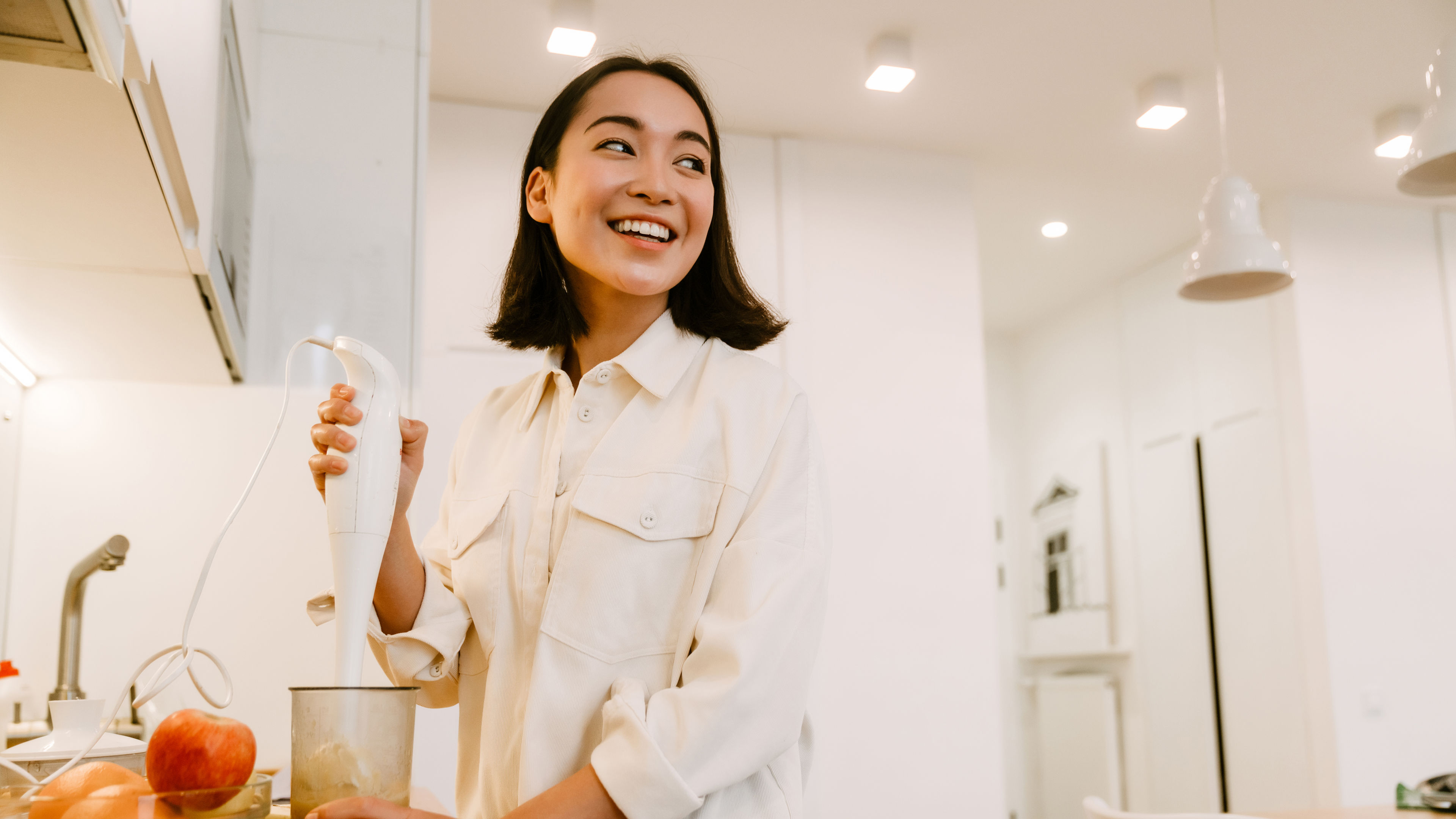 A young Asian woman is cooking