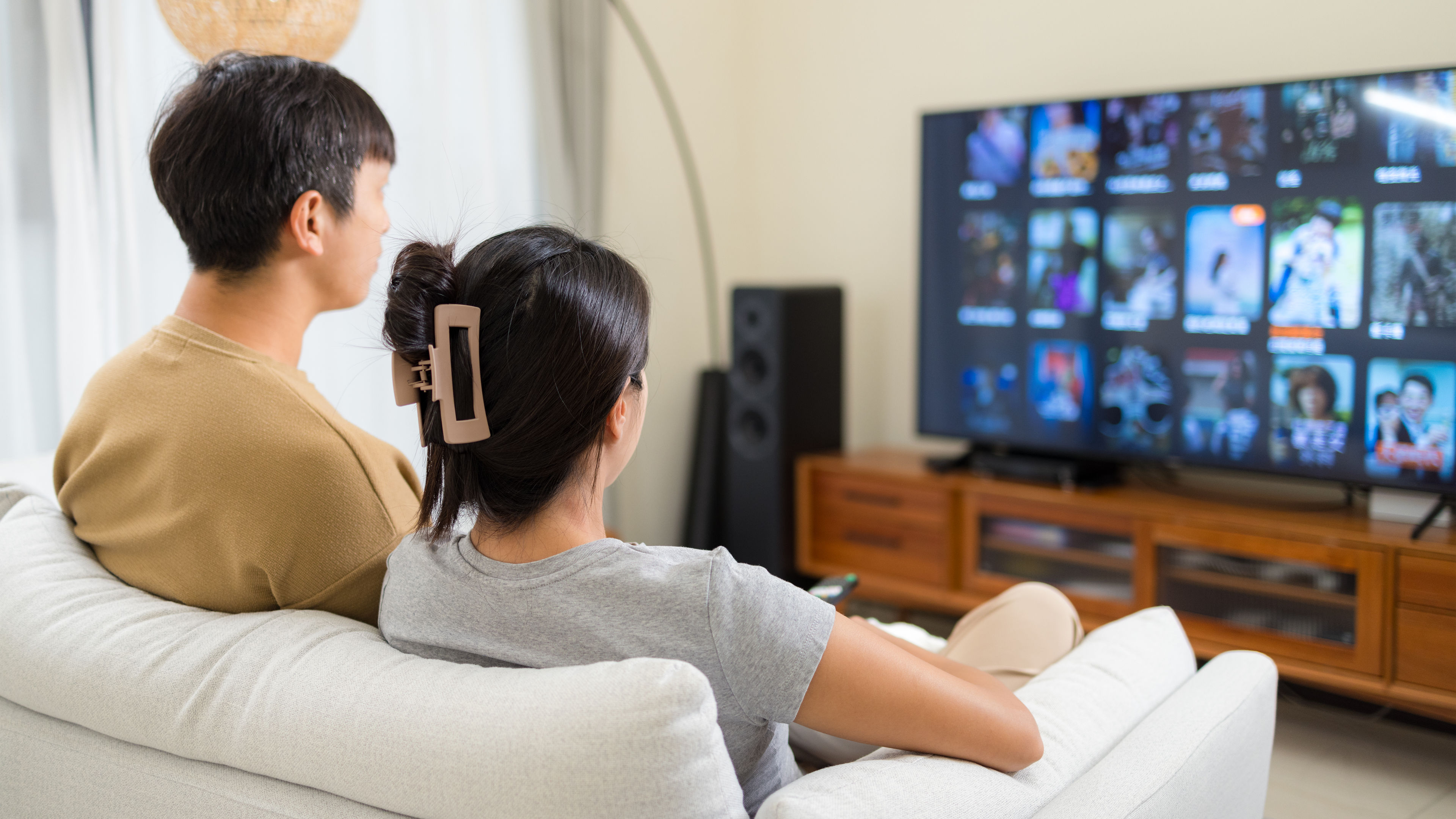 Couple watch TV at home