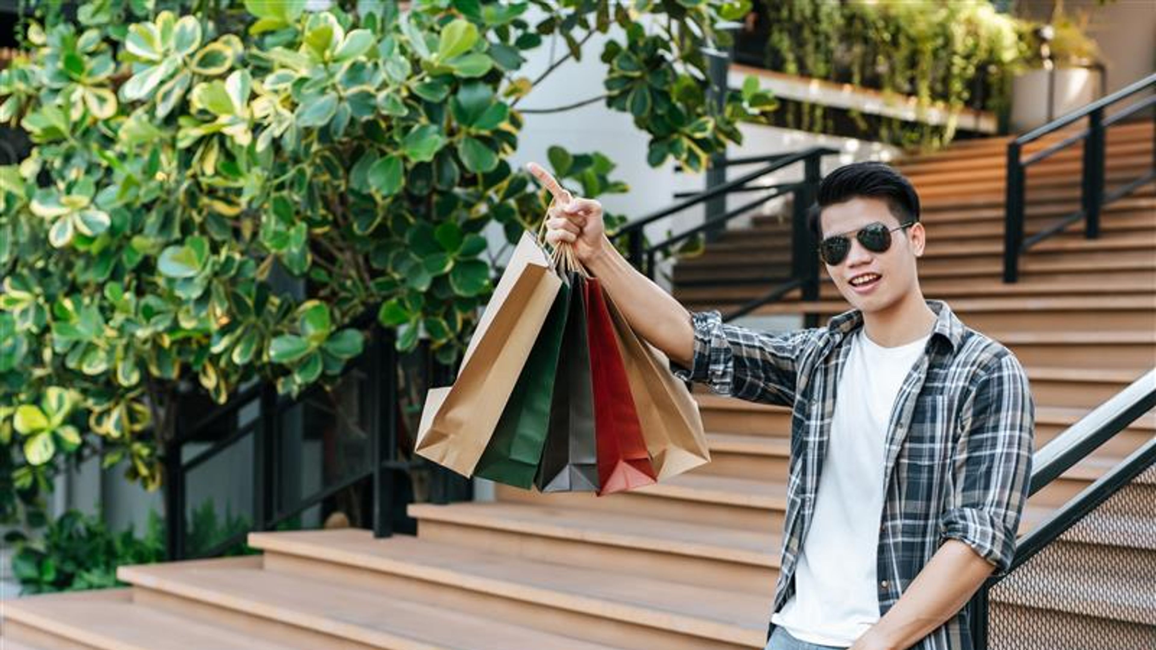 Handsome man in sunglasses with shopping bag