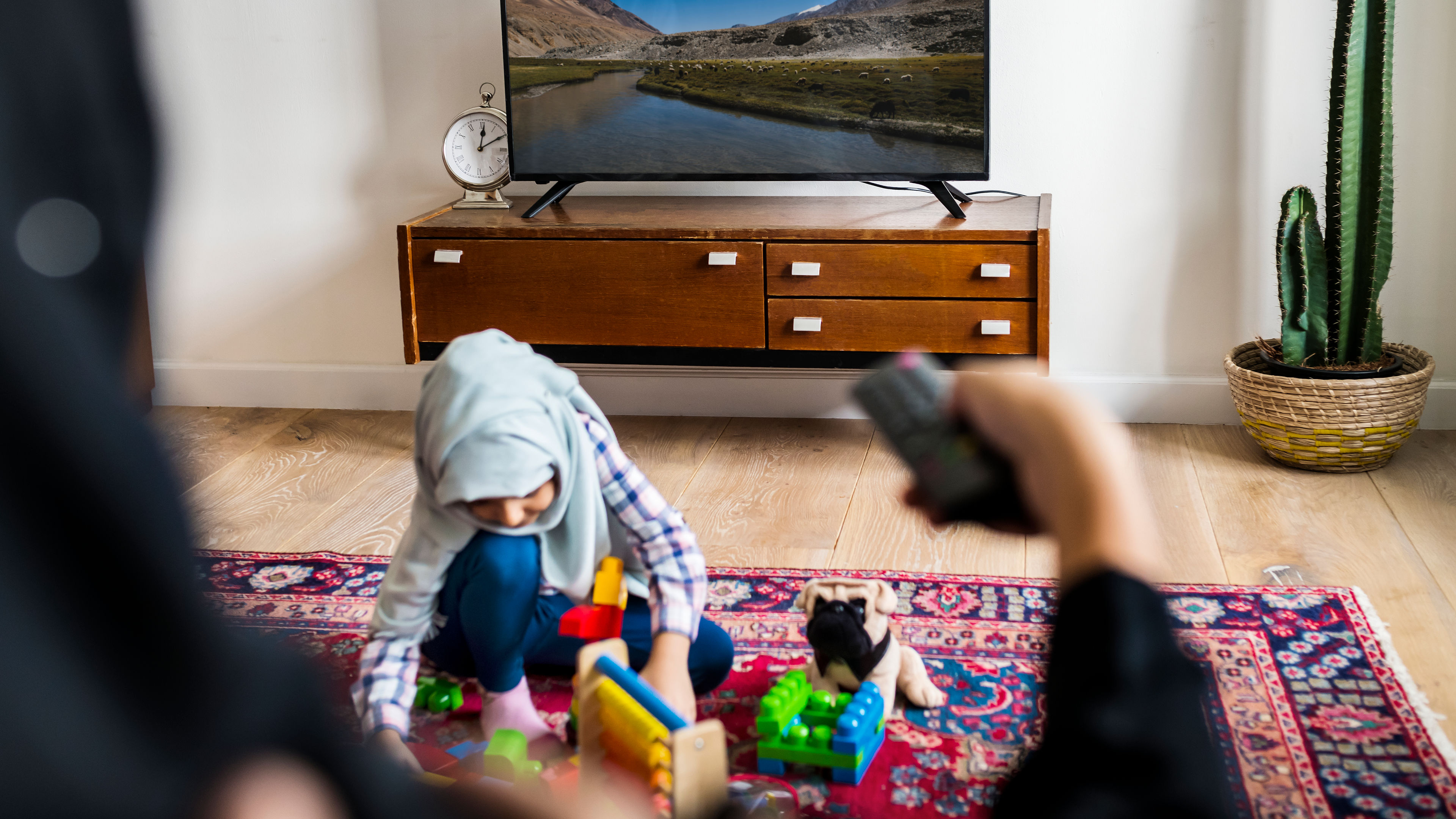 Muslim family relaxing and playing at home