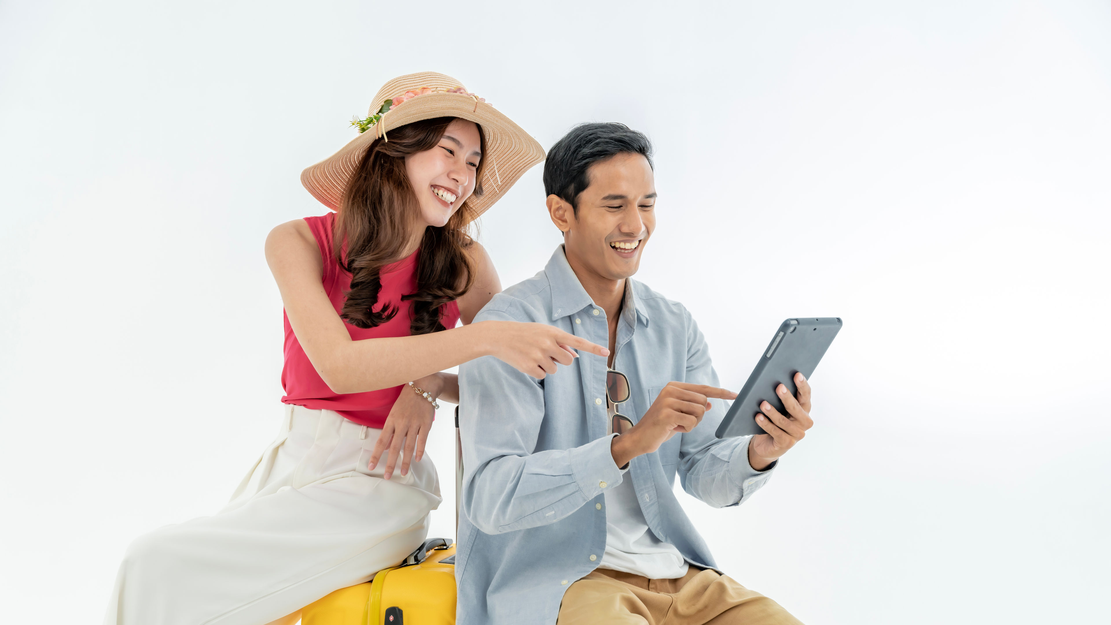 Portrait of an Asian couple with their suitcases