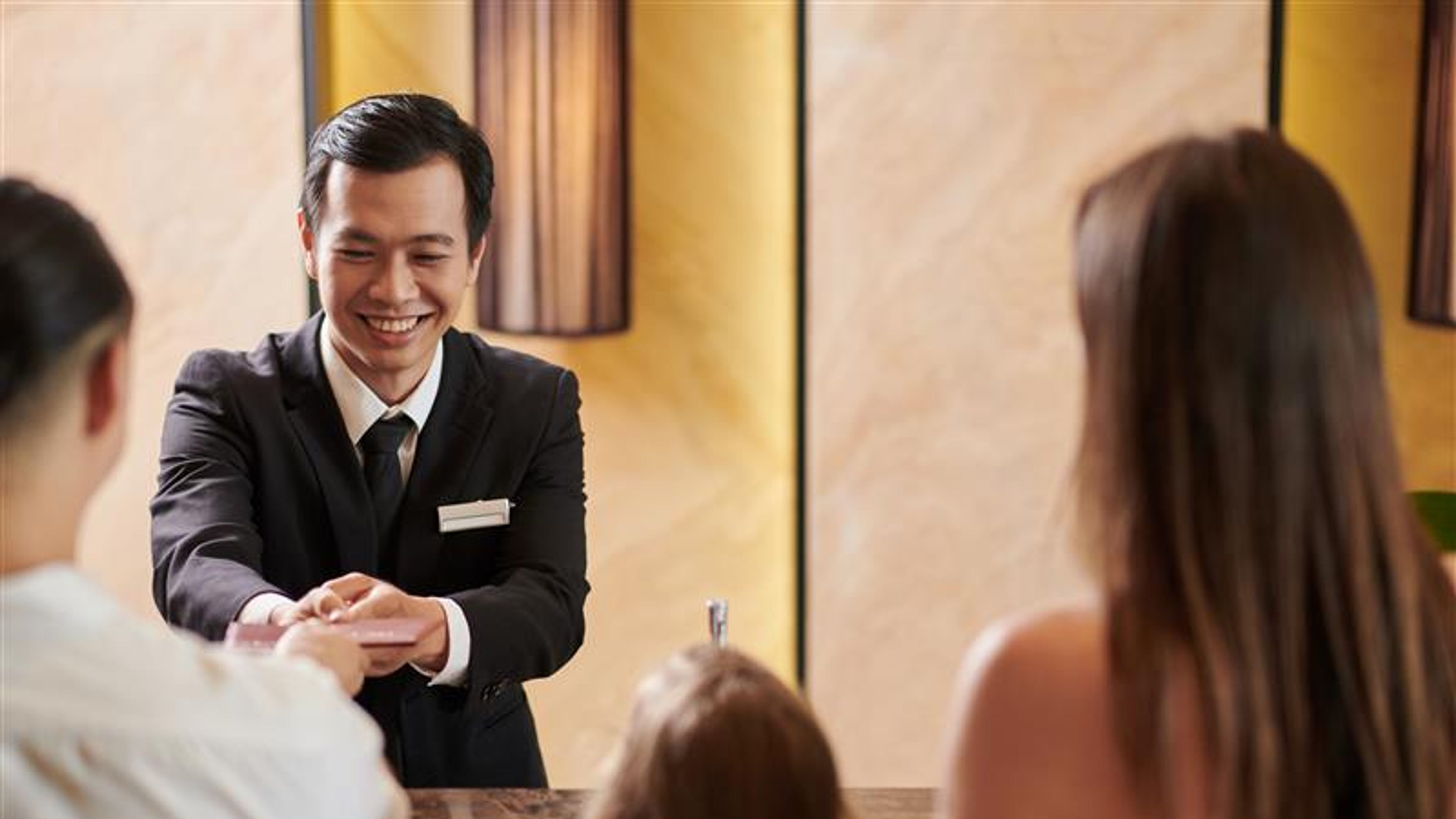 Receptionist giving key to the customer