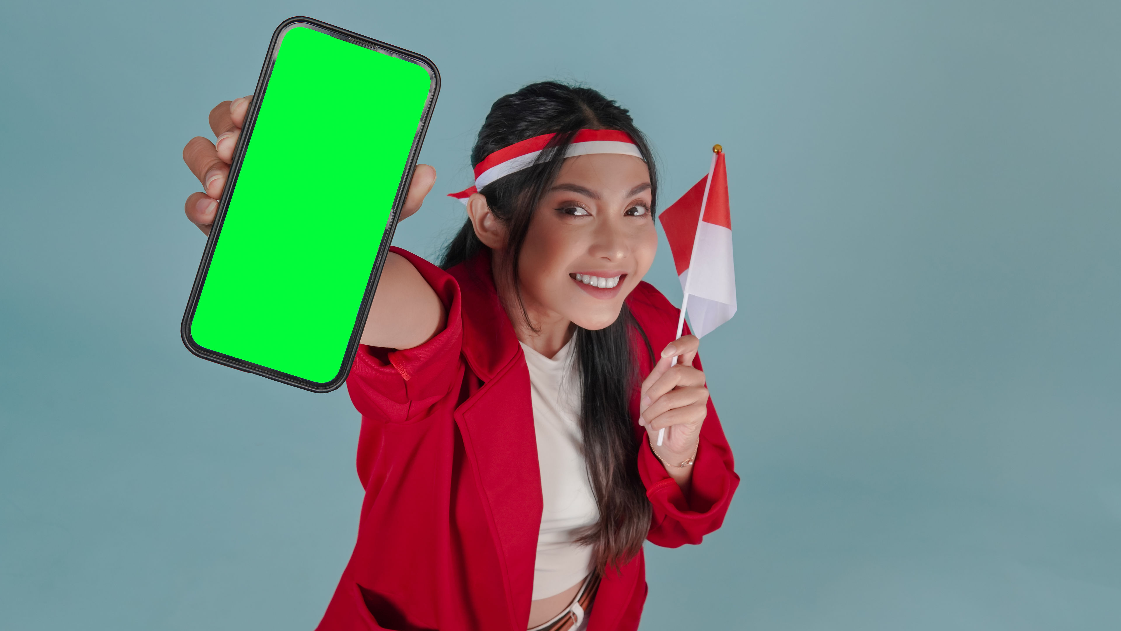 Smiling Woman Holds Phone and Flag 