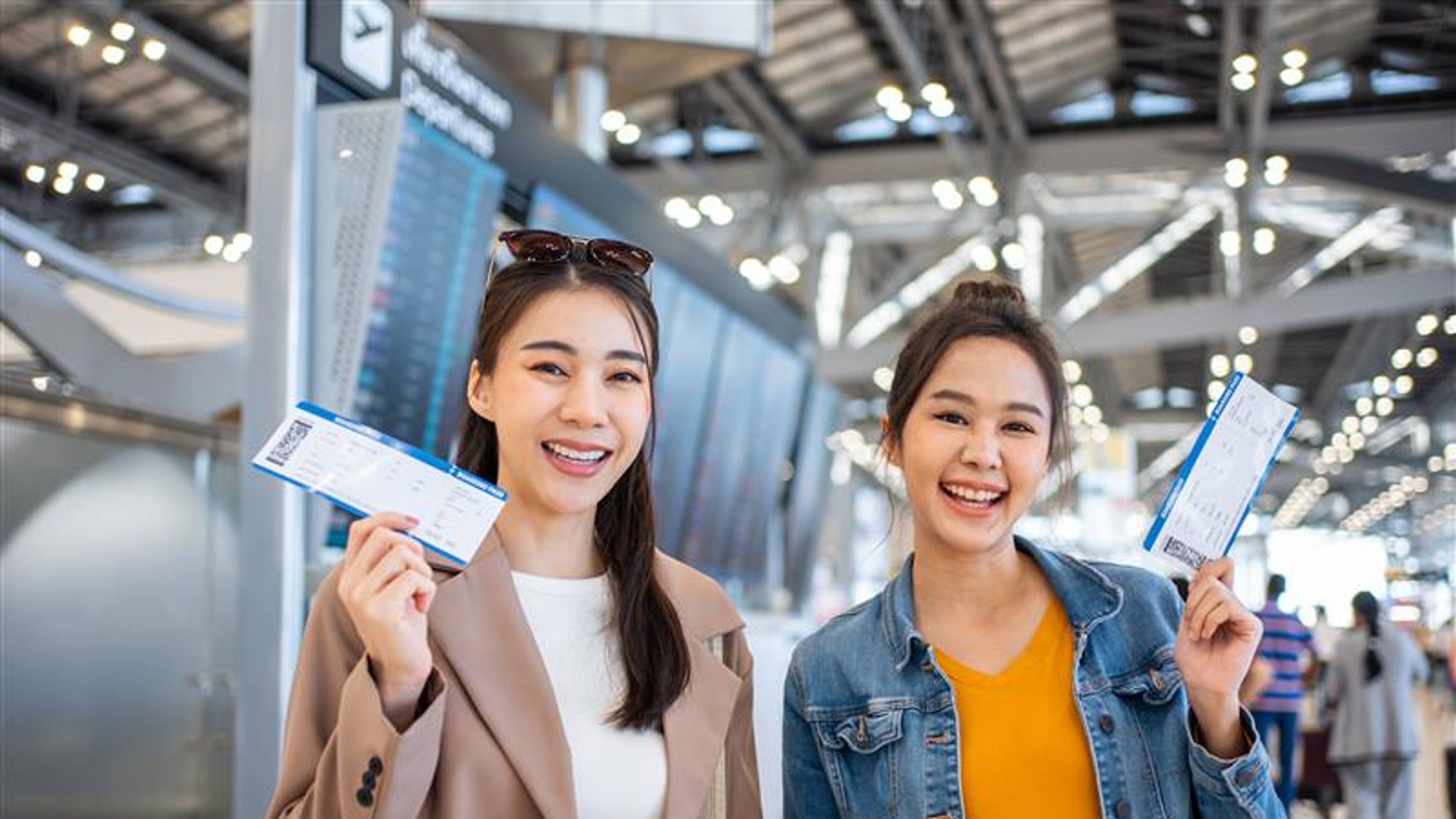 Two girls with flight tickets