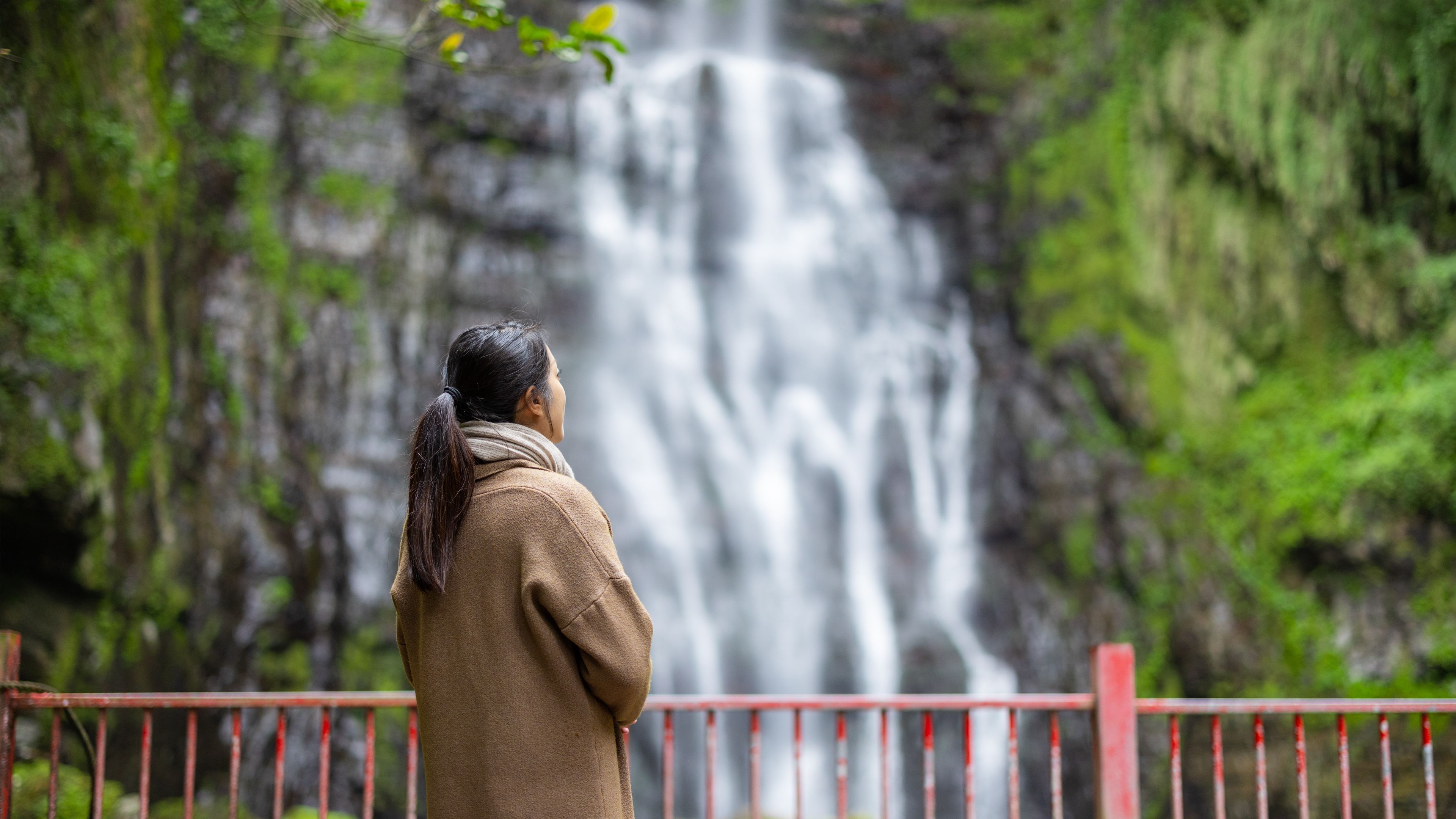 Woman looking at waterfall.
